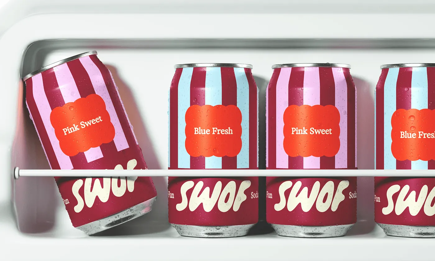 Four condensation-frosted cans on a refrigerator shelf.